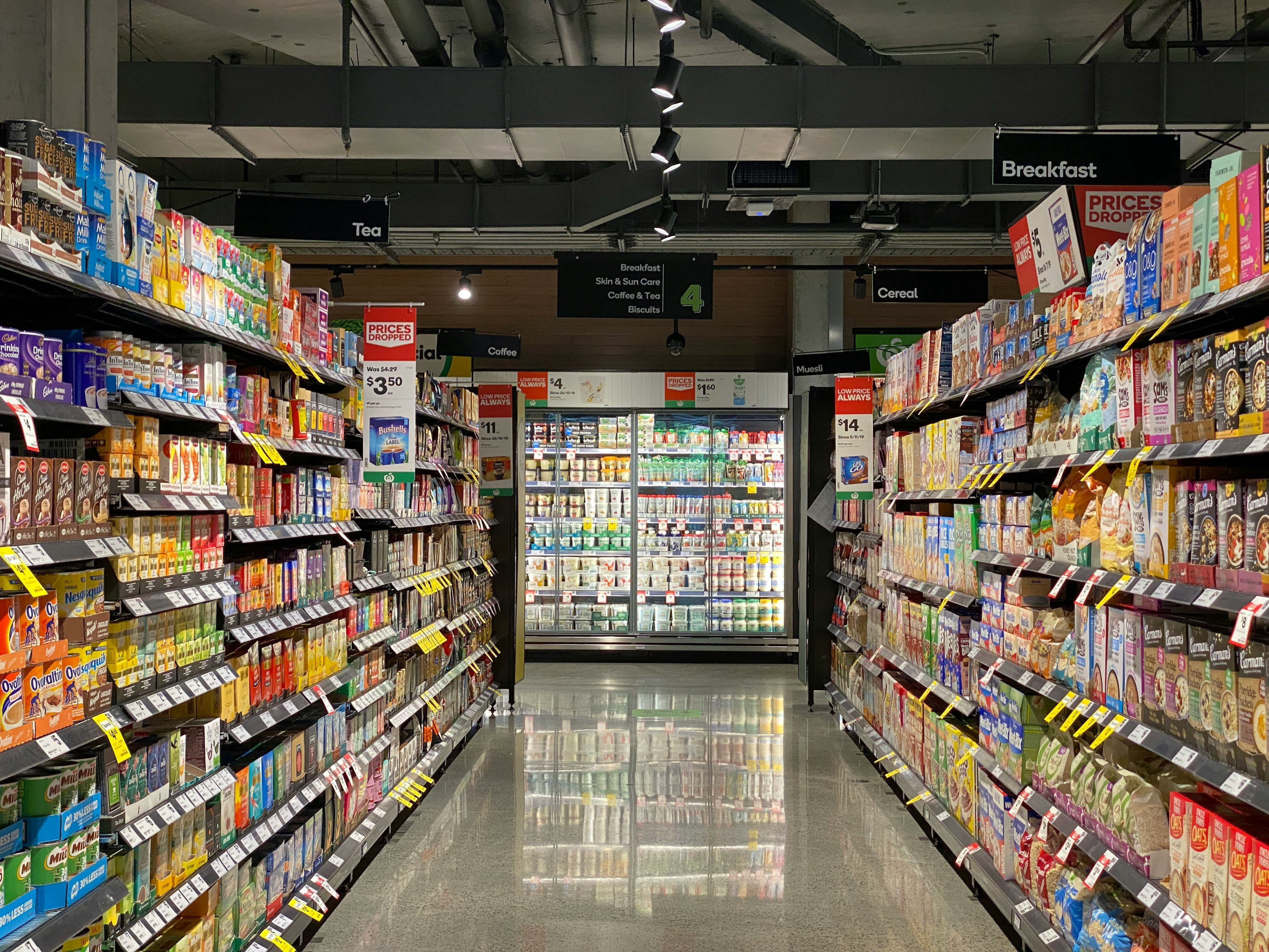 An aisle of a packed grocery store. Photo by Franki Chamaki on Unsplash.